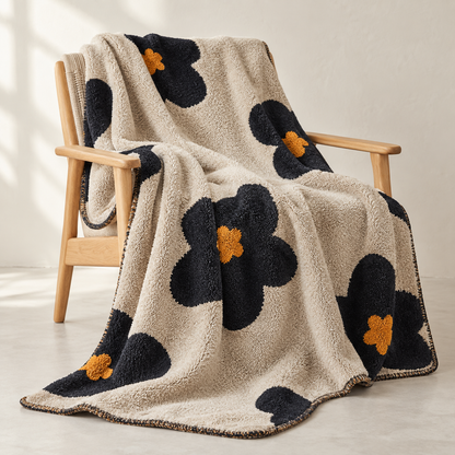Cozy Bloom Plush Blanket in Beige draped over a chair