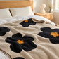 Cozy Bloom Plush Blanket in Beige styled on a bed
