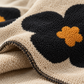 Close up of Cozy Bloom Plush Blanket texture and trim